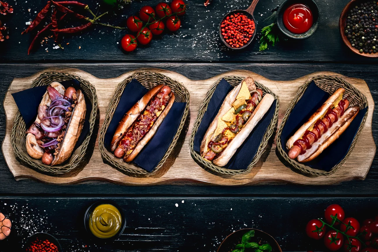 Cztery hot dogi z różnymi dodatkami z menu K20